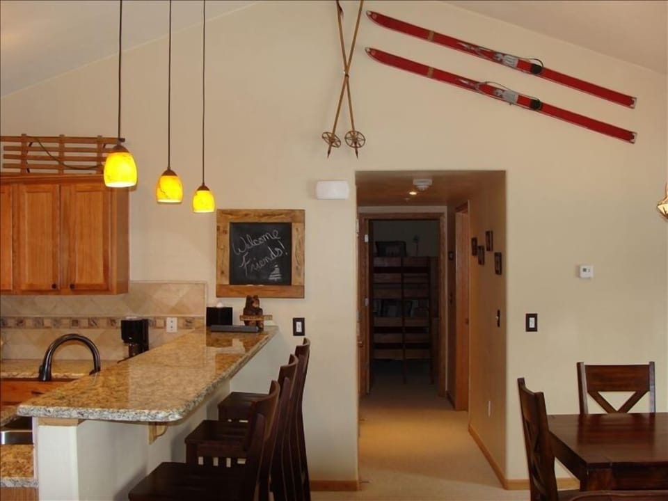Plenty of space with a large dining table and bar seating.