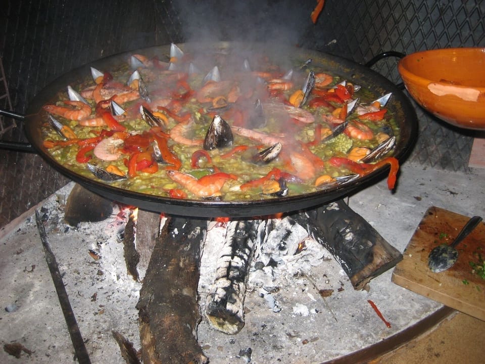 Paella made over rustic fire pit  