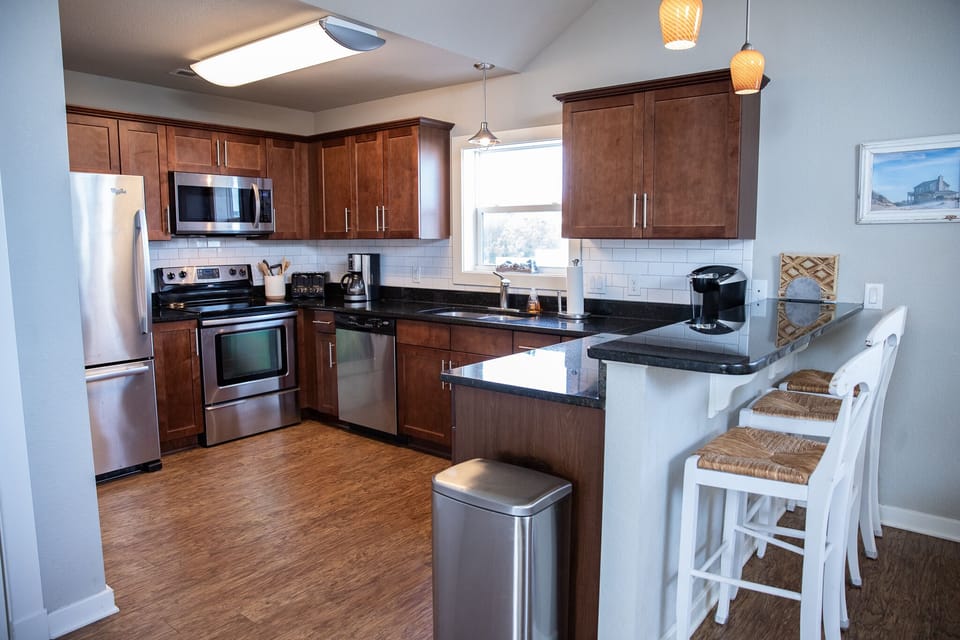 Well-equipped kitchen with seating for 6 plus four bar stools. 
 