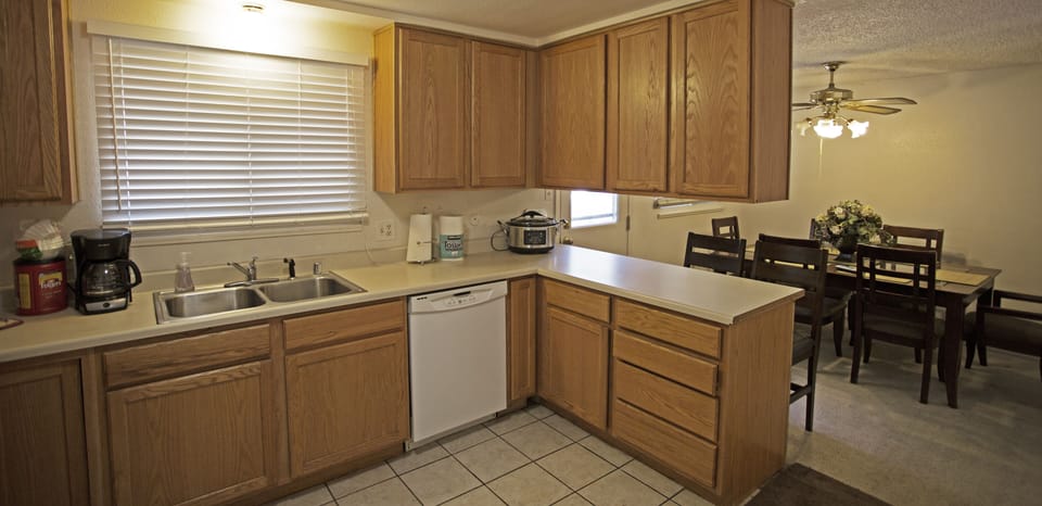 LARGE KITCHEN FULLY STOCKED WITH BREAKFAST BAR AND DINING FOR SIX.