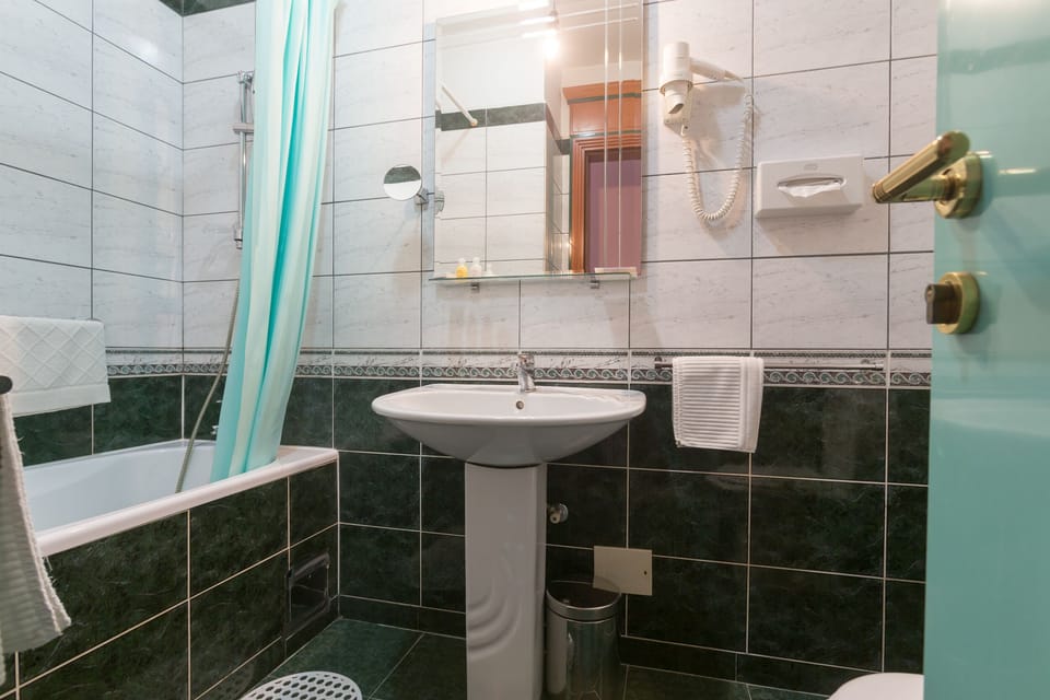 Private Bathroom Contains a Bath. Linens, Towels and Free Toiletries are There.