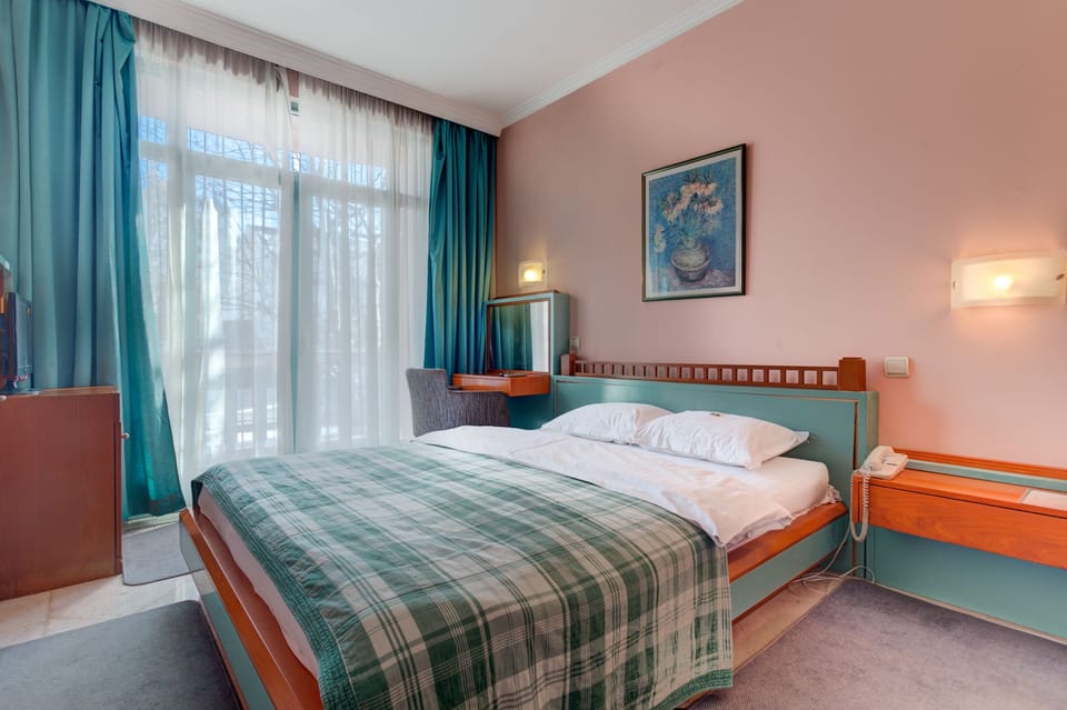 Queen-Size Bed is in the Room, as Well as Flat Screen TV with Cable Channels. 