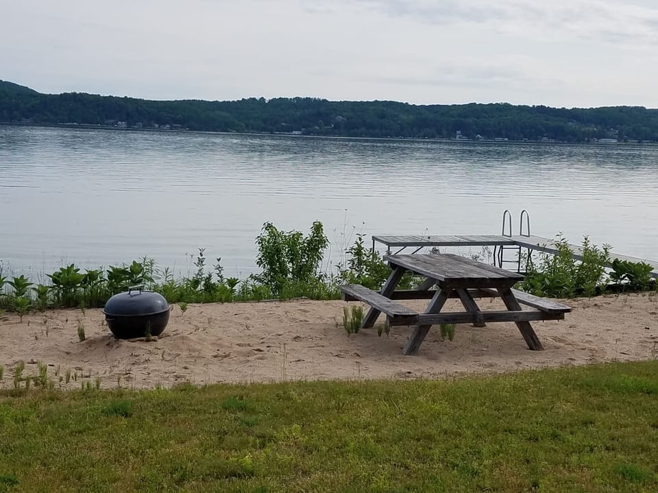 Beach area with fire pit and dock