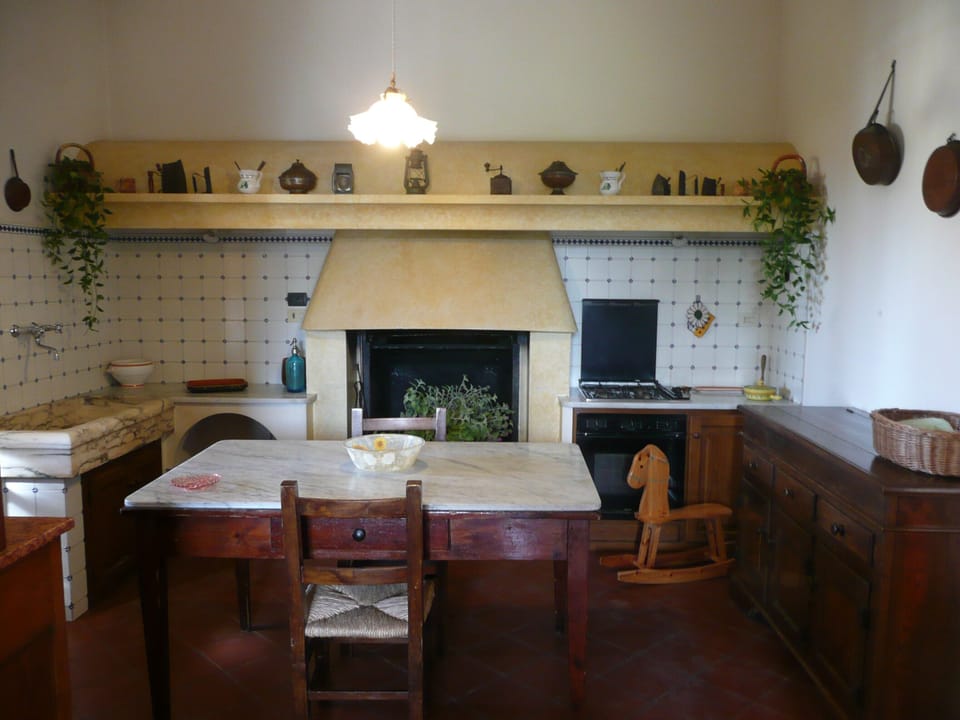 Typical Tuscan kitchen with marble sink & fire