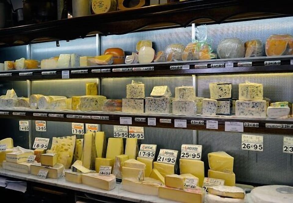 Inside the fabulous cheese shop, right on the corner.  One of the best in Paris.
