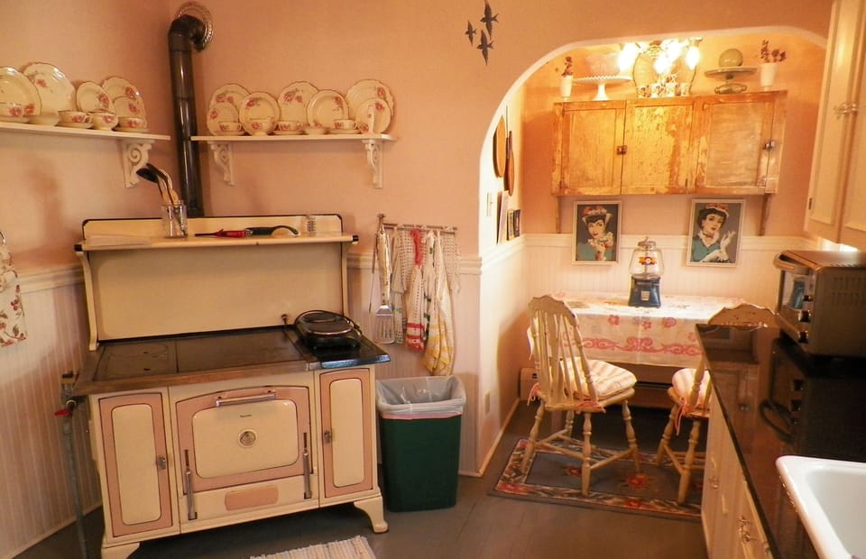 Kitchen with gas burning stove. Hot plate, electric skillet and crock pot.