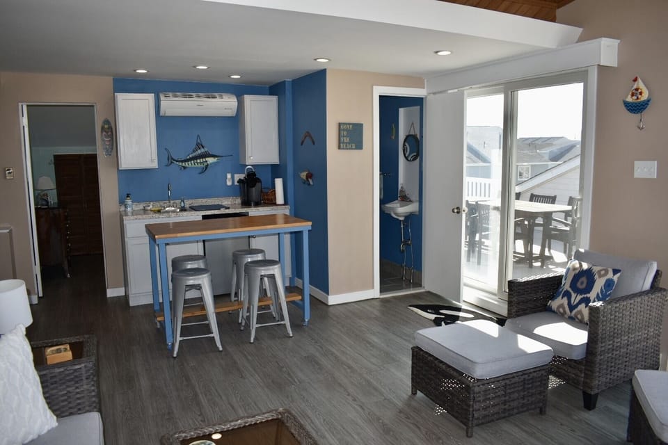 3rd floor living space with 2 seating areas, games, TV, mini kitchen & 1/2 bath
