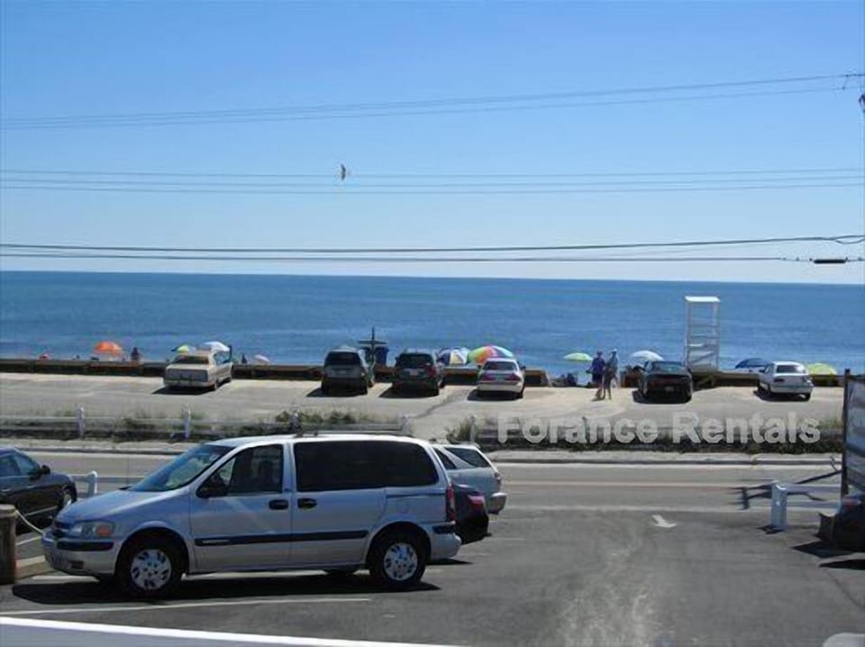 Looking at beach directly across street from complex parking lot