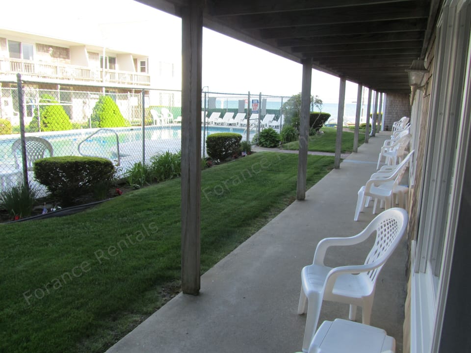 Outdoor seating area; view of pool plus the ocean is at far end