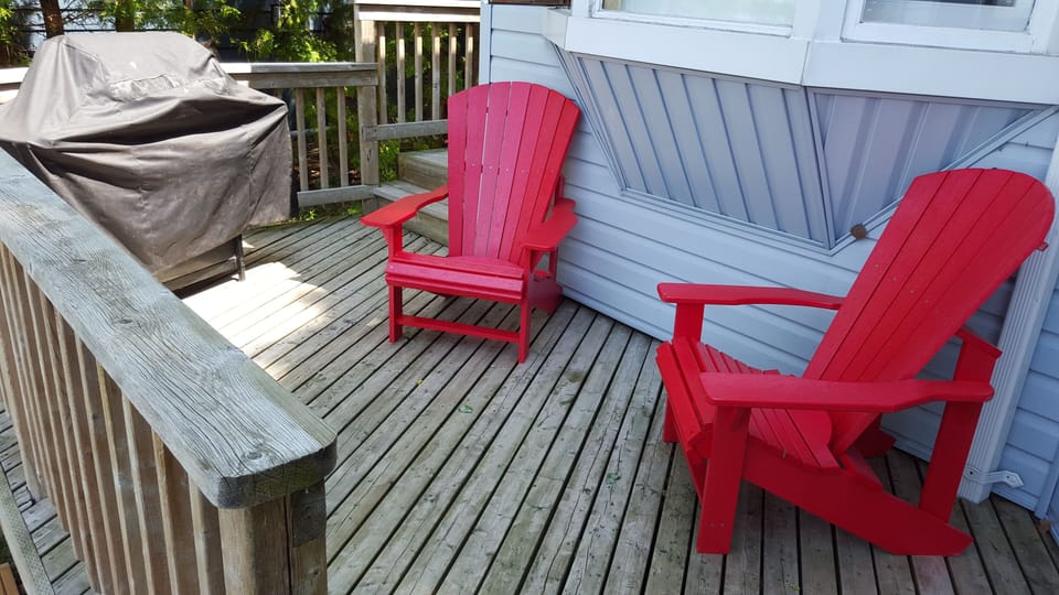 BBQ and chairs to lounge in on deck attached to main cottage.