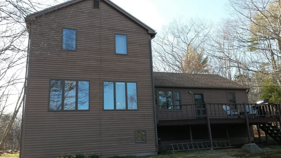 Back of house. The deck and windows overlook the bay.