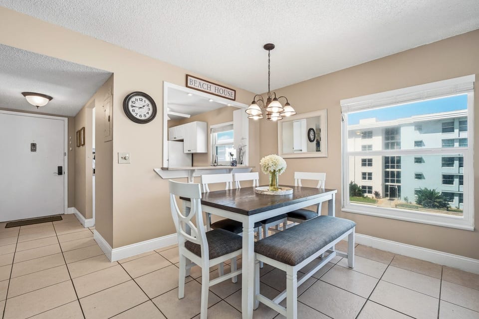 Sunlit and inviting, the bright oceanfront dining room offers a stunning pool view from its charming corner window