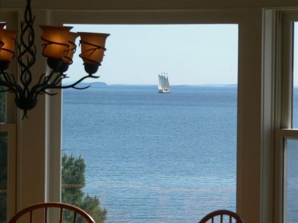 View of a passing schooner over the round table for six in the kitchen.