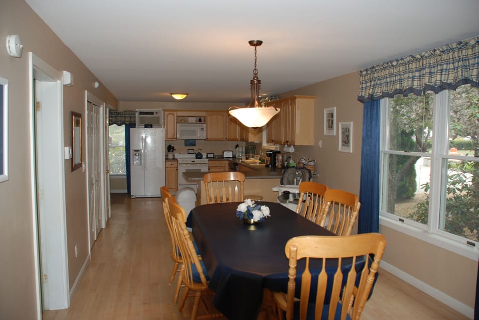 View of dining room table and kitchen