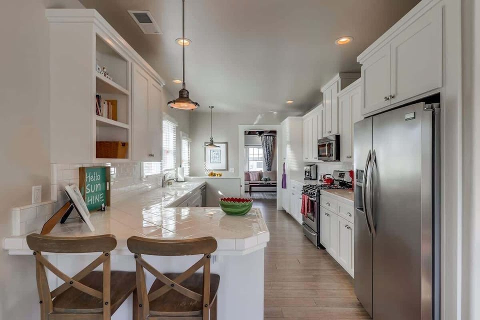 Bar sitting on back side of kitchen.