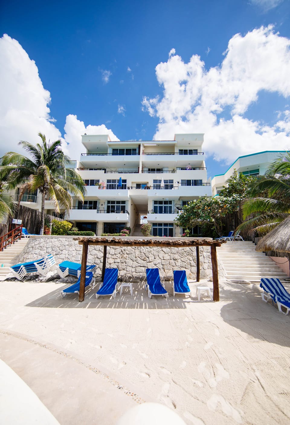 Pool deck on upper level, sandy beach w/ shade below