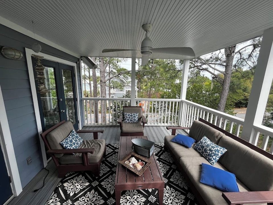 Covered deck with ceiling fan and great seating off of living room. 