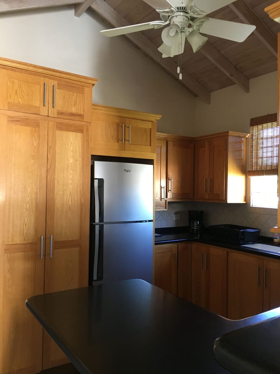 Authentic hand made red oak kitchen cupboards, with hidden laundry facility.