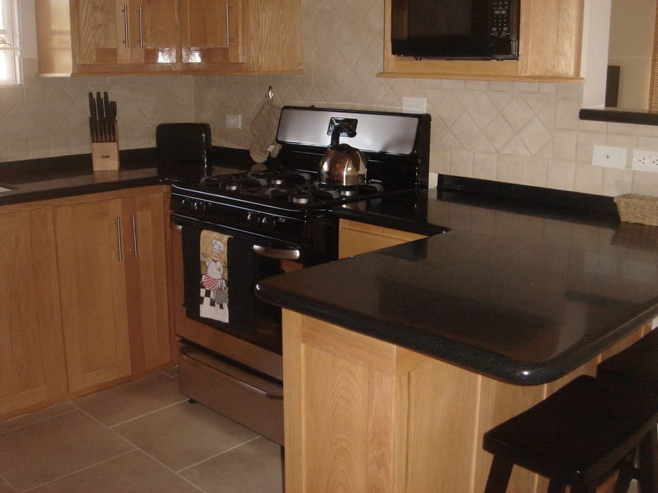 Coffee maker, toaster and contemporary gas range make for easy meal prep.