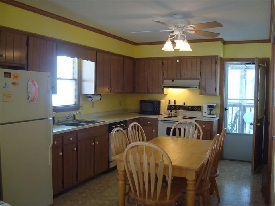 Fully-equipped kitchen leads to screened-in back porch