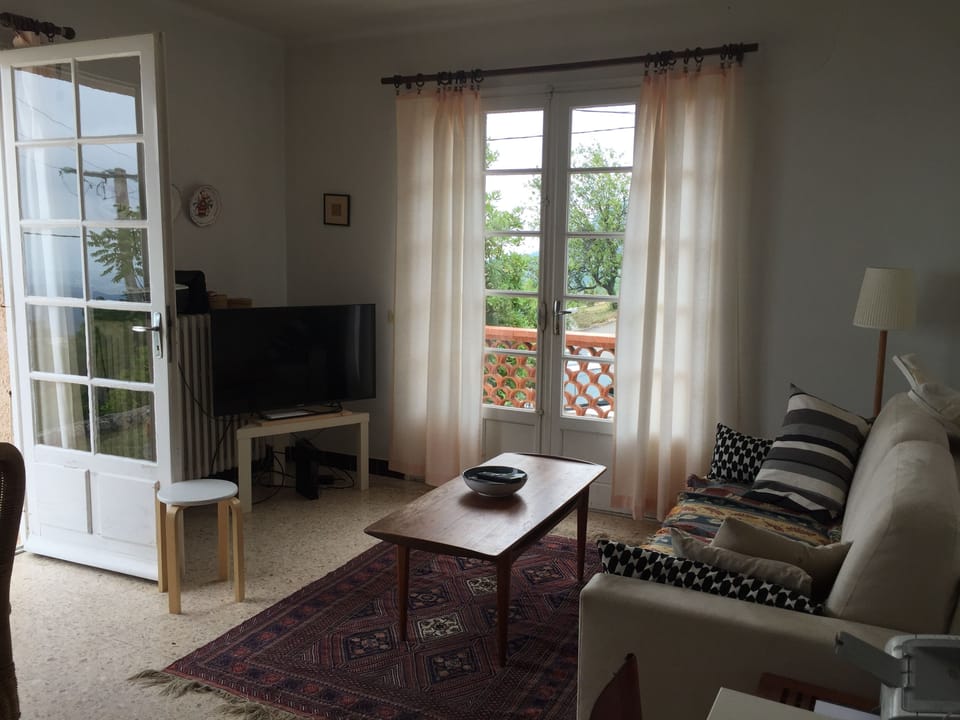 This is the living room-right window faces the street, left window the terrace