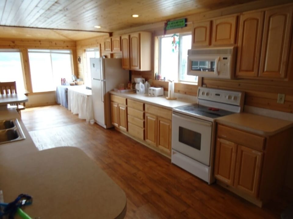 A well stocked kitchen. Electric stove. Microwave. Toaster. Serving platters.