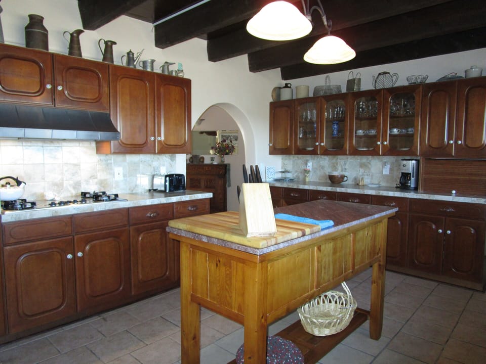 Kitchen equipped with plenty of cooking gear, toaster, blender & coffee maker.  