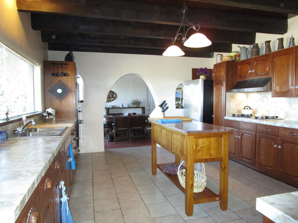 Roomy kitchen with center island.  Gas cooktop, oven, microwave & warming tray. 