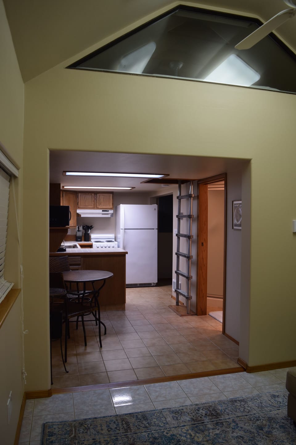 Back of "cabin" with full kitchenette and access to kids loft