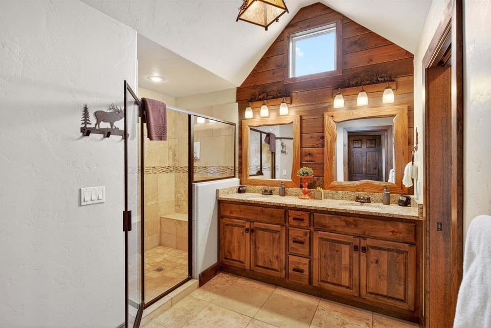 Upper-level king suite bathroom with large walk-in shower and double vanity