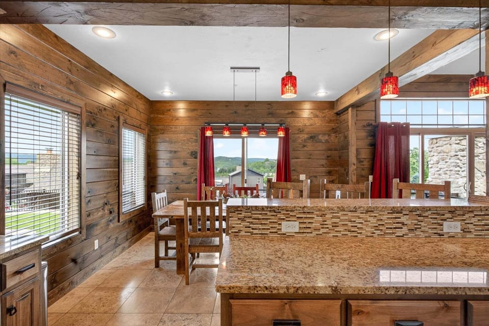 Breakfast bar with barstool seating for 3, dining room behind with seating for 8