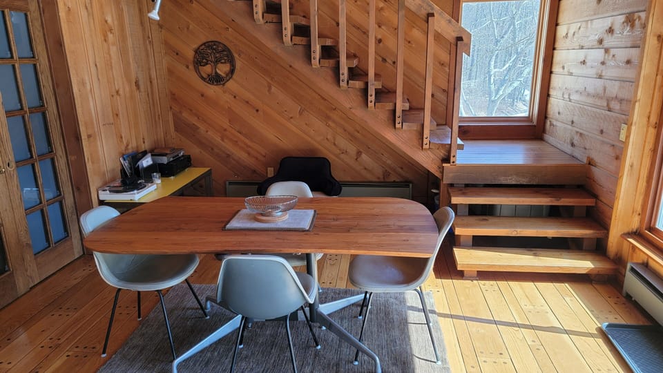 Dining area, stairs, and the door to the ground floor bedroom. 