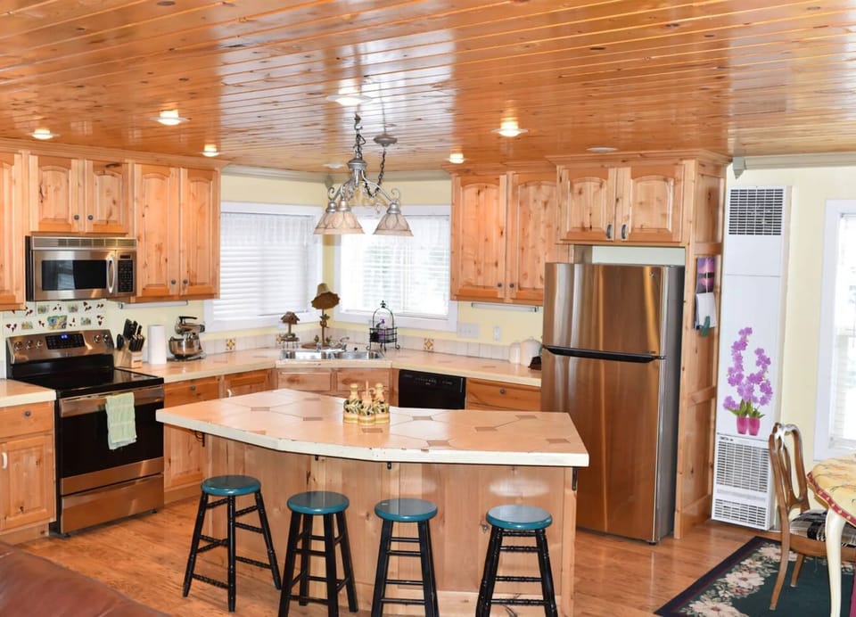 The modern rustic-style kitchen offers a spacious place to cook and enjoy a meal.