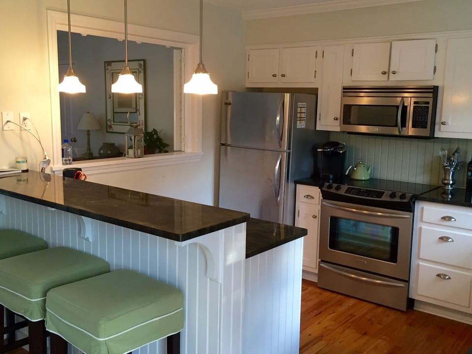 Modern kitchen with stainless steel appliances, including dishwasher.