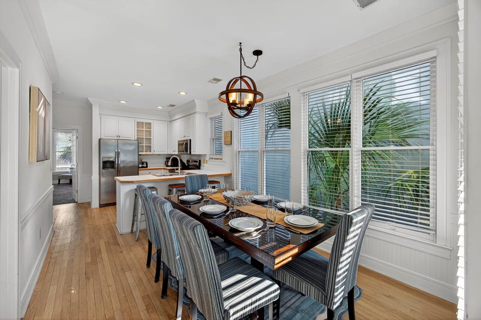 Modern dining room table with well stocked open concept kitchen.