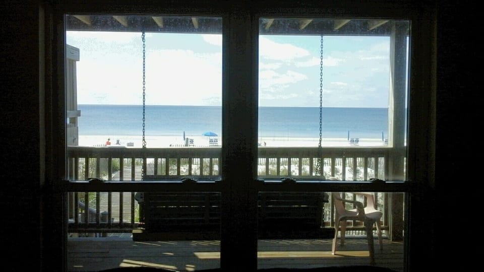 View from living room window of your own large deck, swing & sugar sand beach