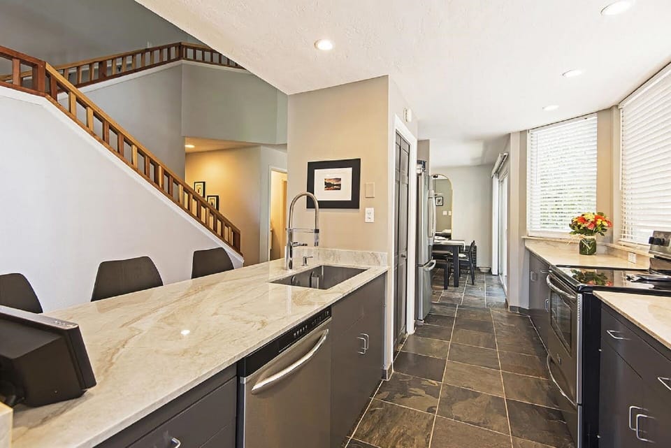Galley kitchen with Perla Venata Quartzite counters. 