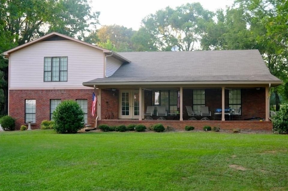 Front view of home looking over the bright golden haze on the meadow.