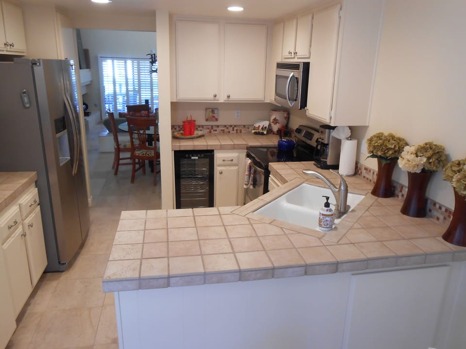Chef's kitchen with wine fridge, new stainless appliances & fully stocked.