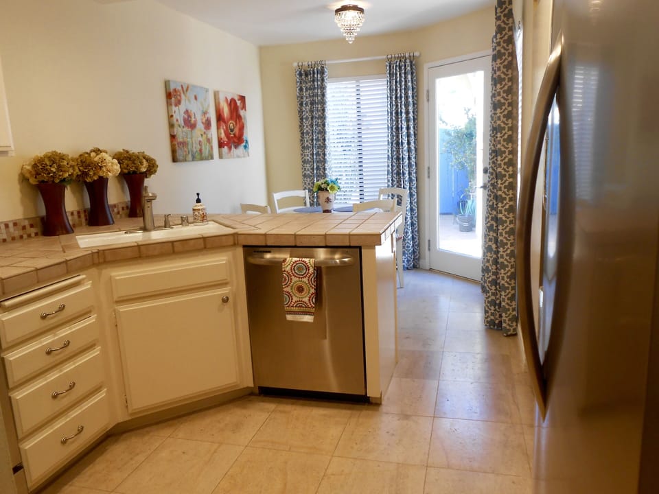 Fully stocked kitchen with new stainless appliances and updated finishes.