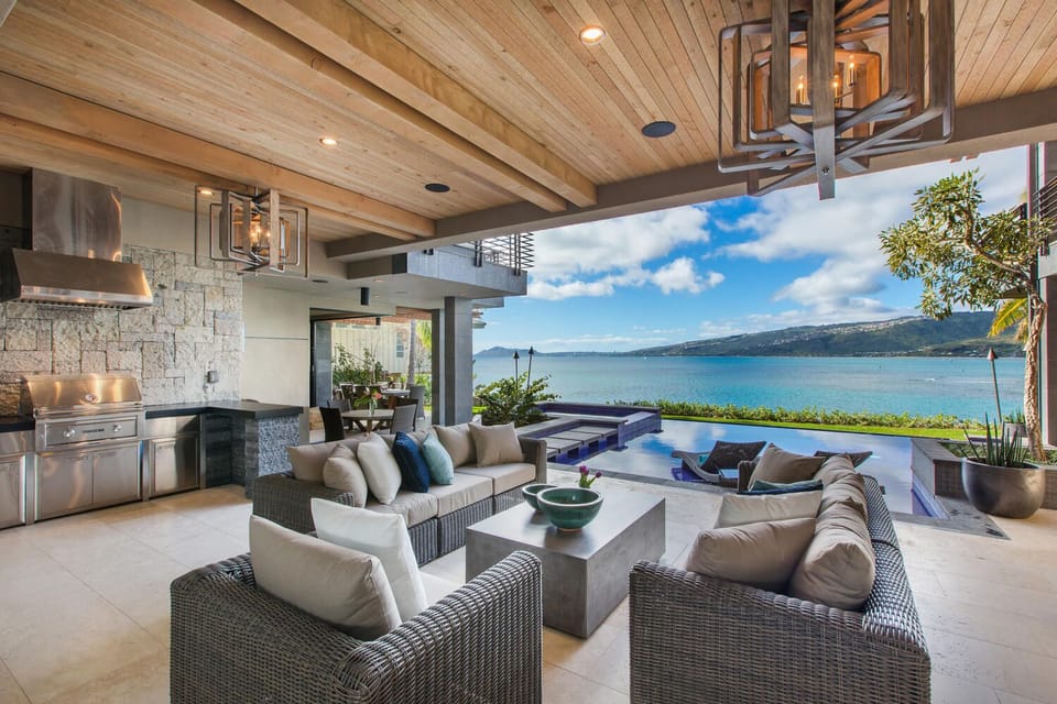 Covered barbecue and lounge area, perfect for casual grilling and evening cocktails outdoors.