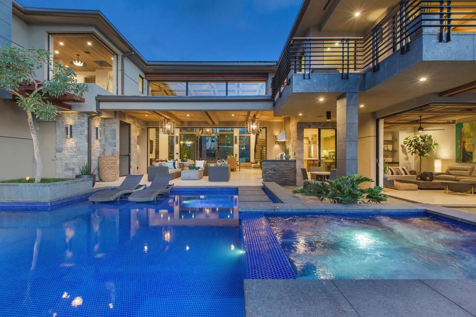 Sparkling pool courtyard at twilight, creating a resort-style atmosphere for evening swims or stargazing.