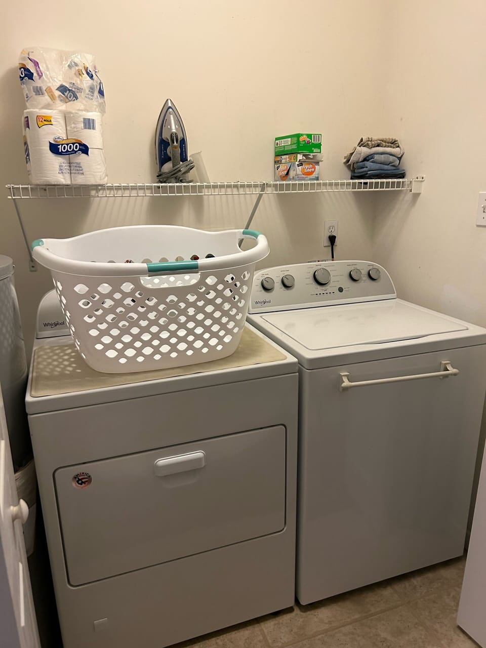 Laundry area includes iron and ironing board.