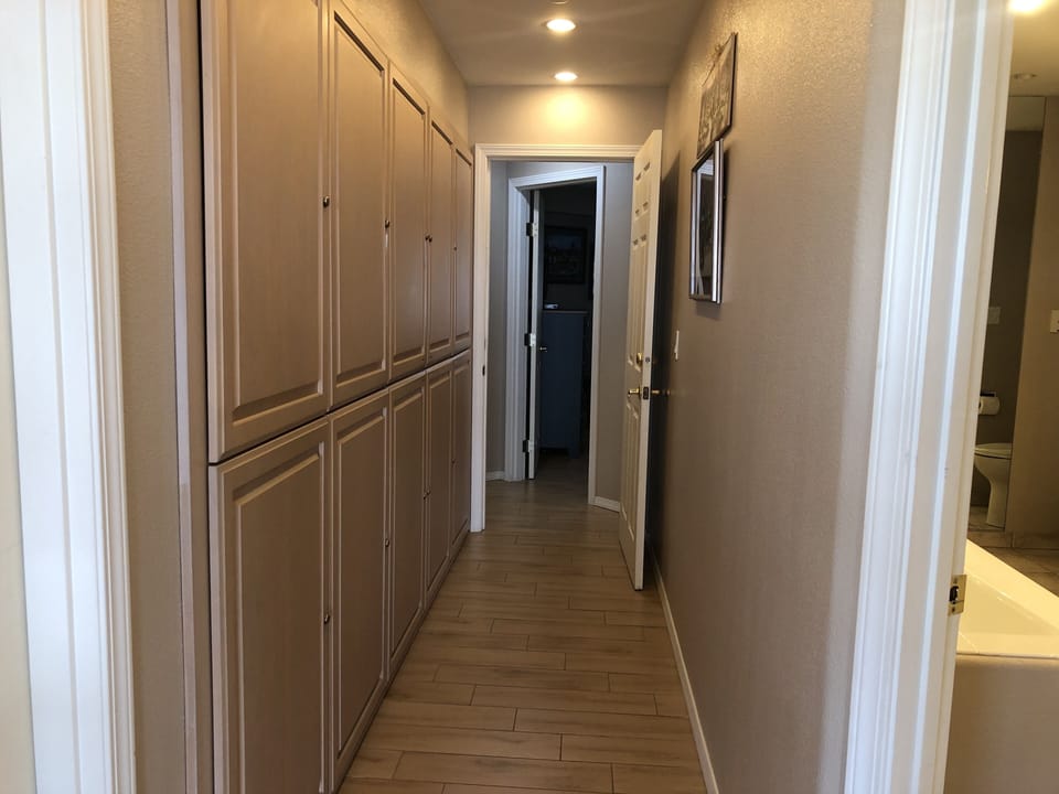 Hallway to oceanfront primary bedroom and bathroom