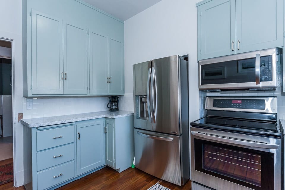 Main floor: Kitchen with new stainless steel appliances, including dishwasher