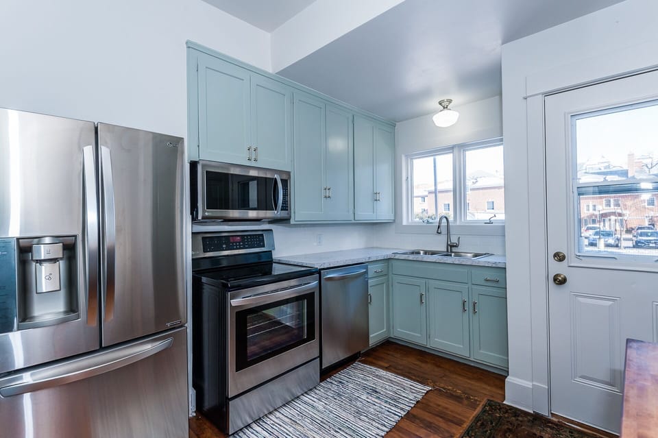 Main floor: Kitchen with new stainless steel appliances, including dishwasher