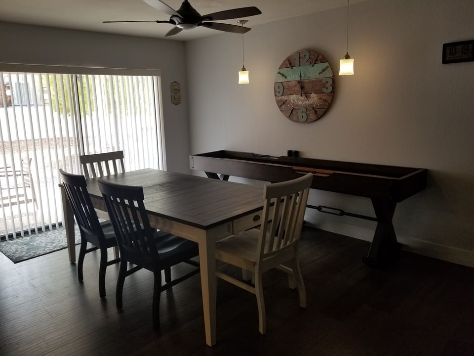 Dining area..  Plenty of seating. 4 chairs and a bench seat. 9' shuffle board 