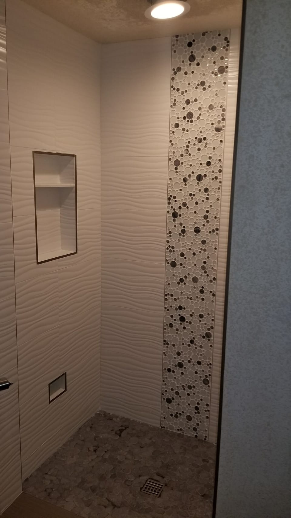 Master shower.  Glass door swings in/out from wall.