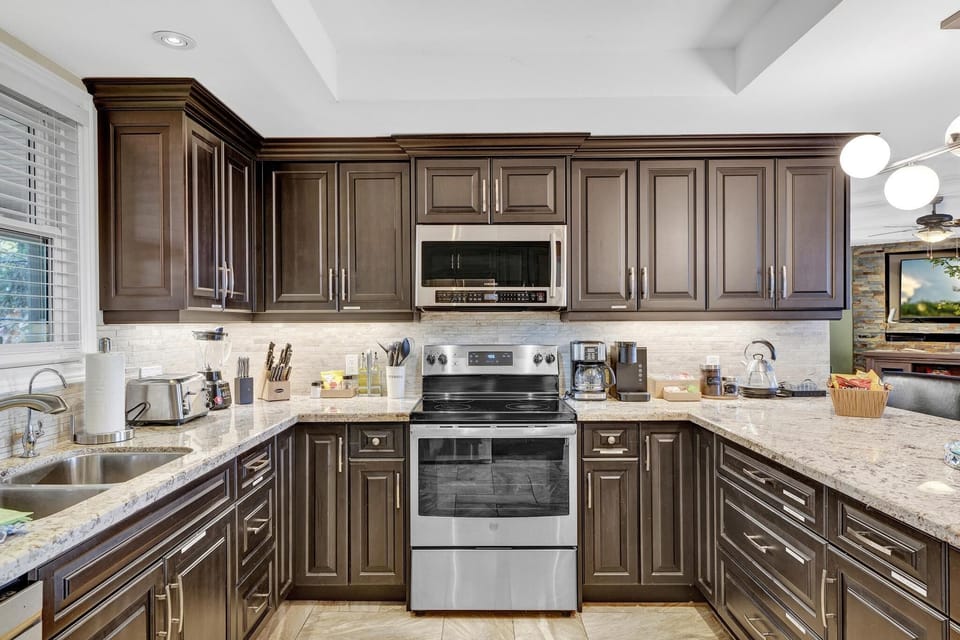 Modern kitchen with stainless steel appliances.