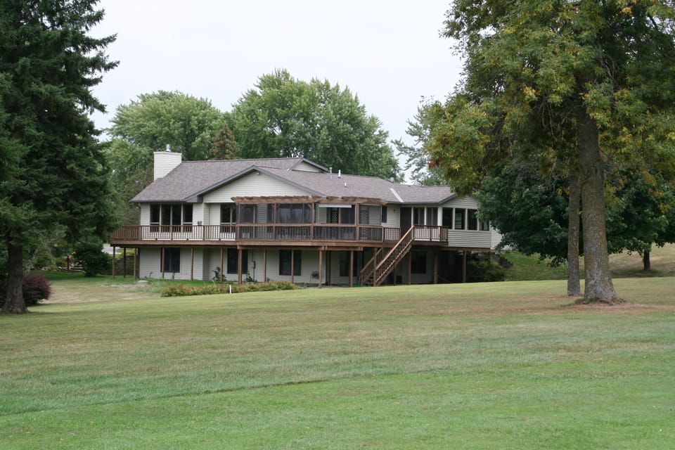 Wrap-around deck with screened patio overlooking back yard and golf course.